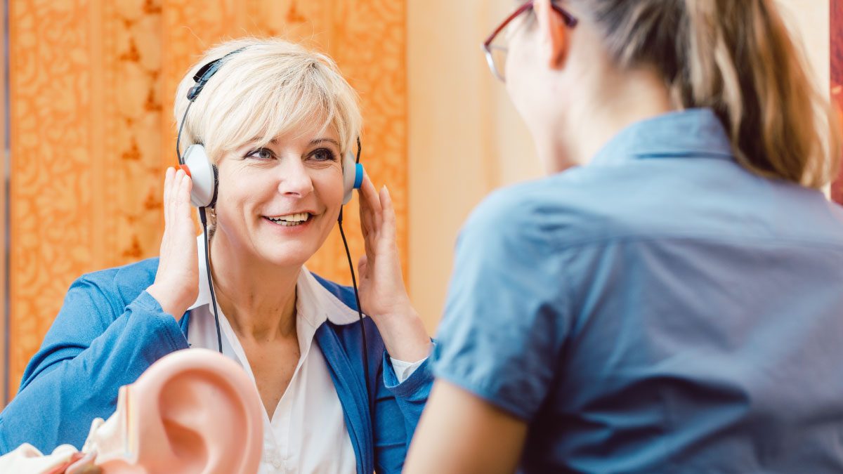 Female patient with female audiology tech during a hearing test